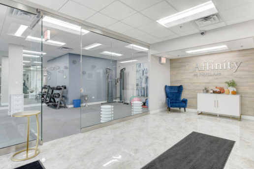bright lobby area leading to fitness room through glass doors
