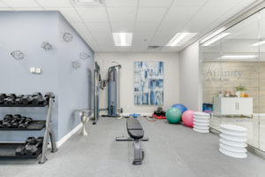 fitness room with various exercise equipment and exercise balls