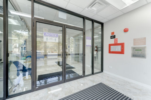 entrance with glass doors with social distancing signs