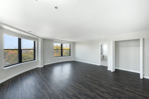 large bright room with wooden floors and large windows